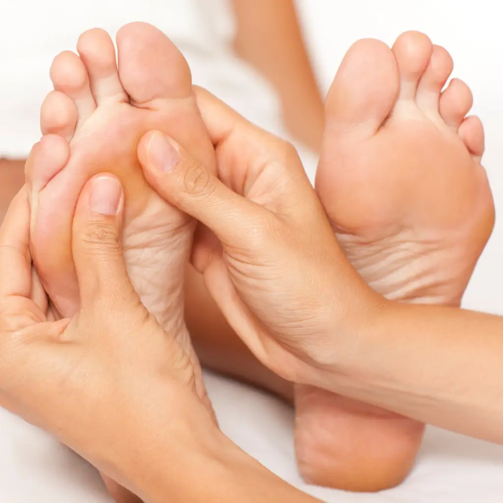 therapist performing foot reflexology